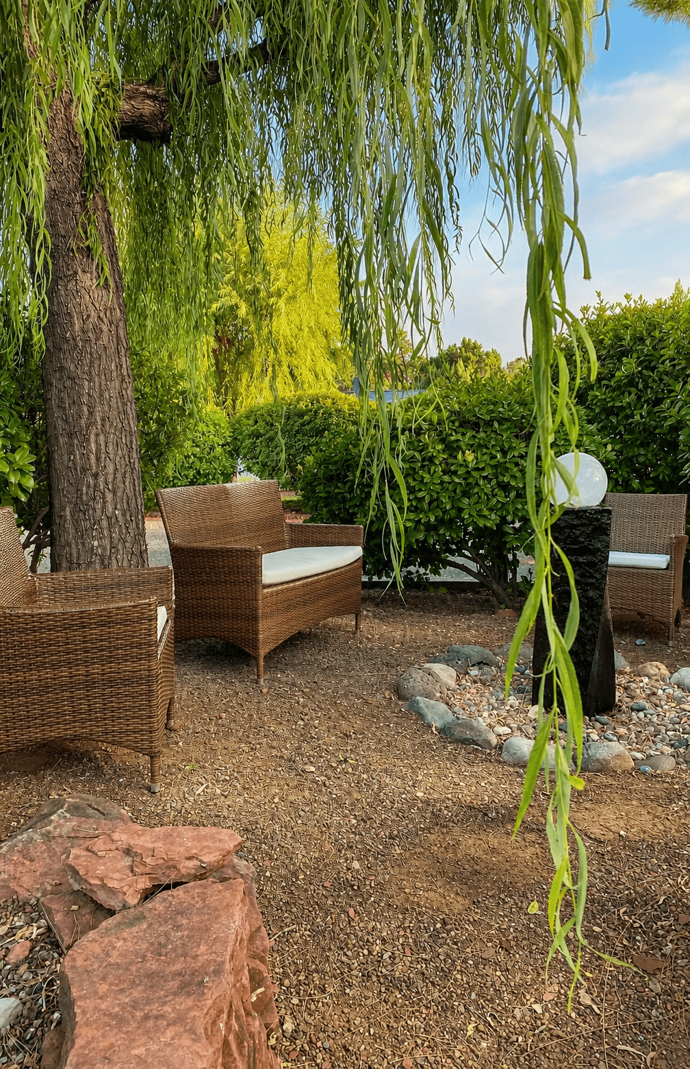 A quiet seating nook beneath a willow tree in the garden outside Guan Yin