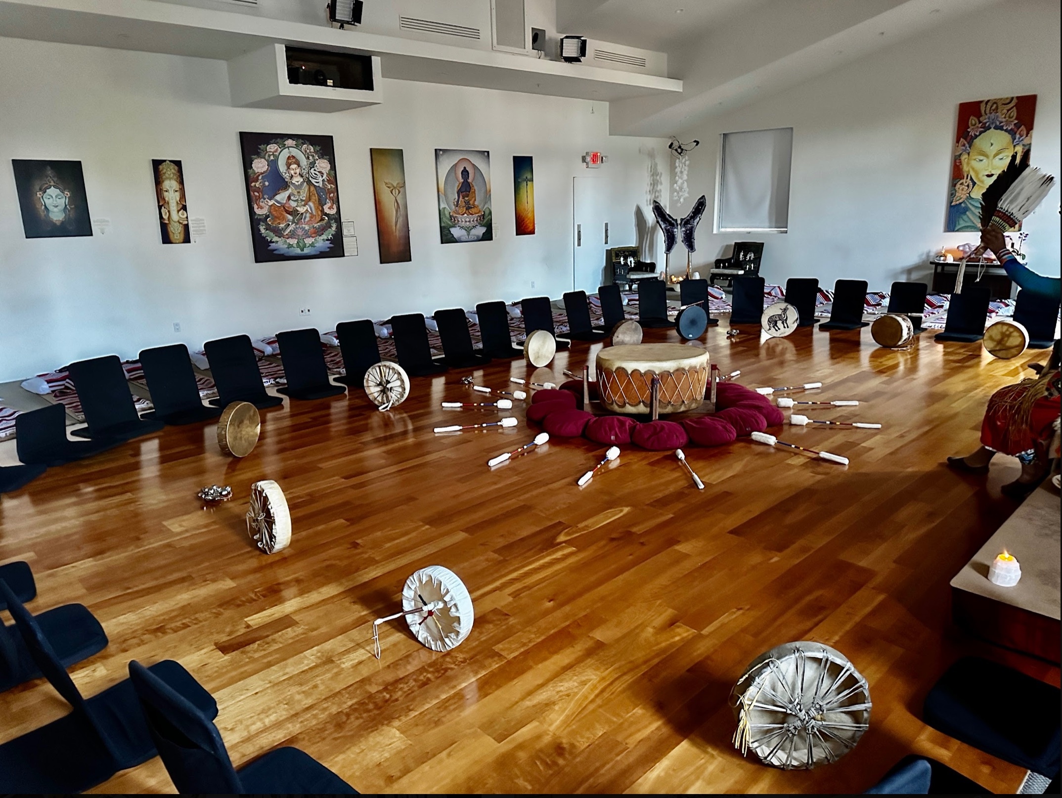 Hand drums and mallets radiating from the center, ready for rhythm and ceremony