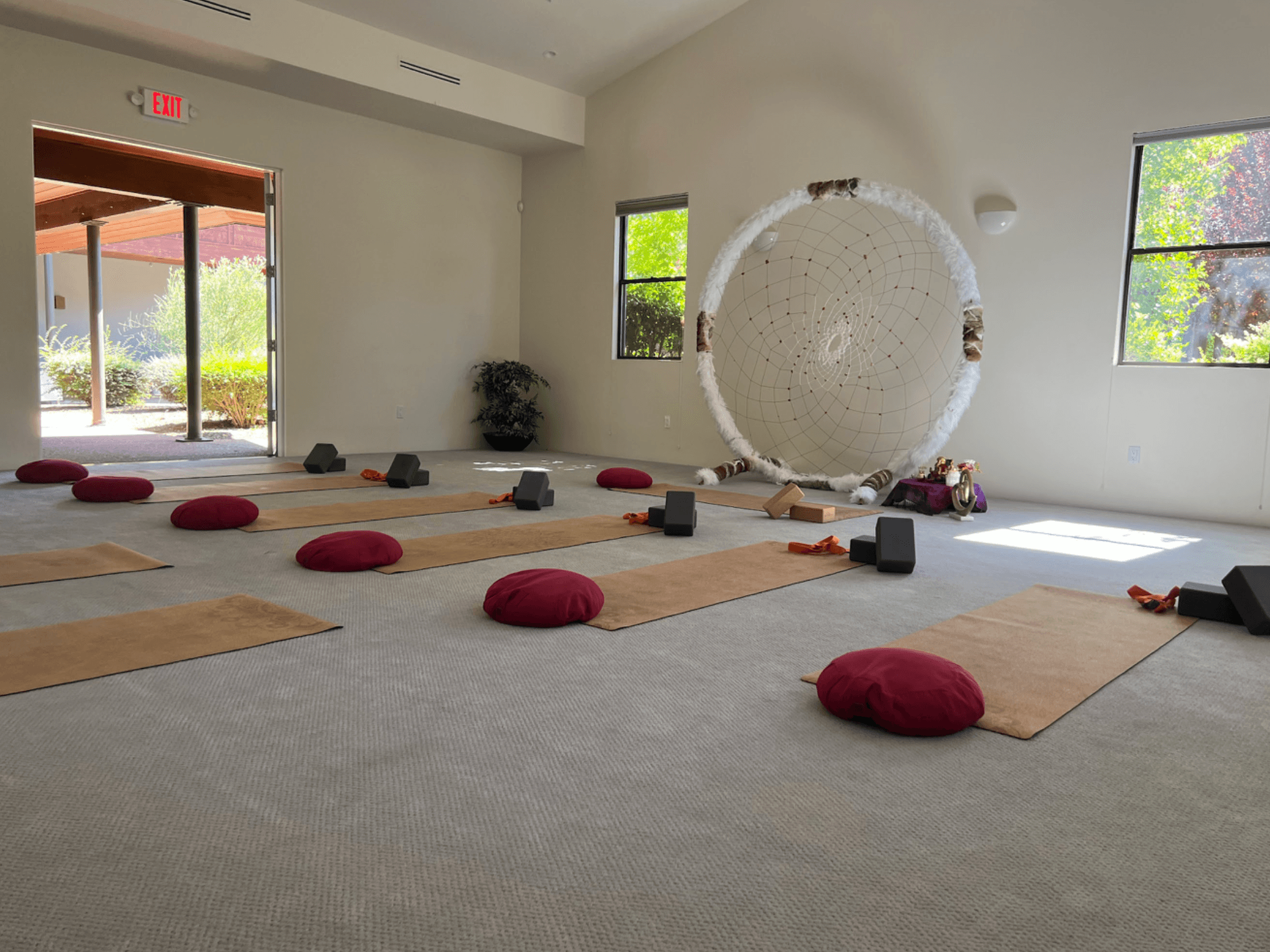 Cushions and mats drawn into a bright circle before the open garden door